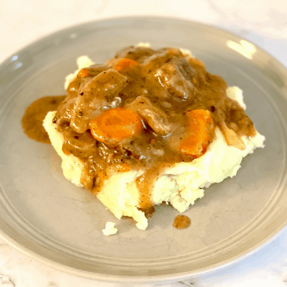 Plate of Beef Bourguignon served over mashed potatoes