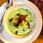 Bowl of Avocado Soup with Bacon and Chile Rubbed Croutons in a pink bowl