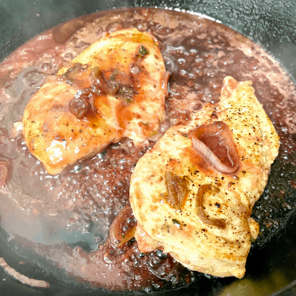 Chicken breasts in skillet finished Raspberry Balsamic Chicken.