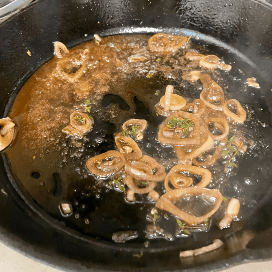 Cast iron skillet with shallots cooking