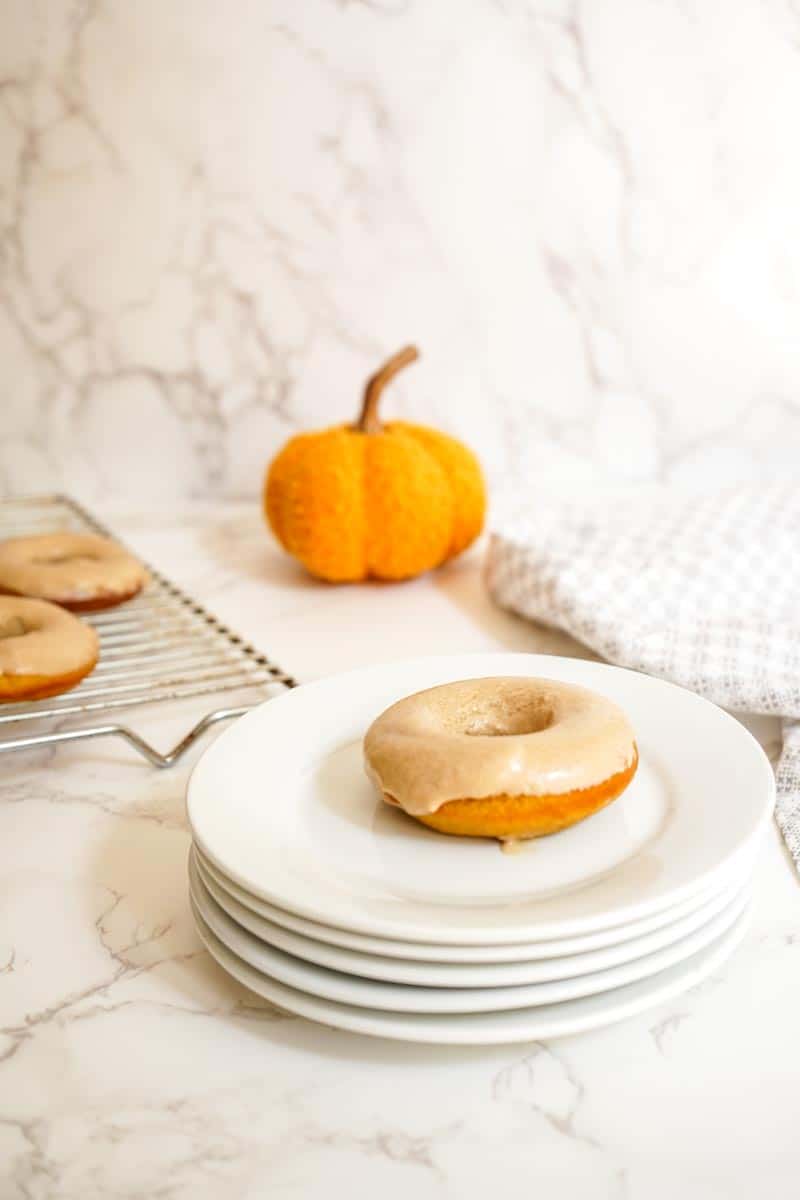 Pumpkin spice latte donut on a white plate