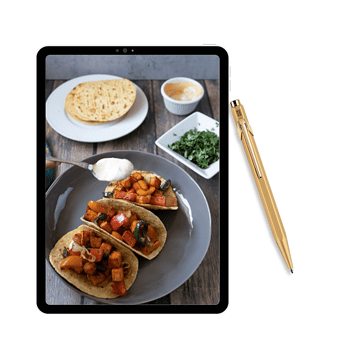 Photo of iPad with tacos, tortillas and chipotle dressing on side